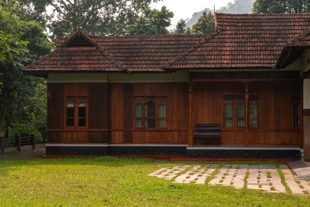 Side view of a traditional Kerala house with lush surroundings