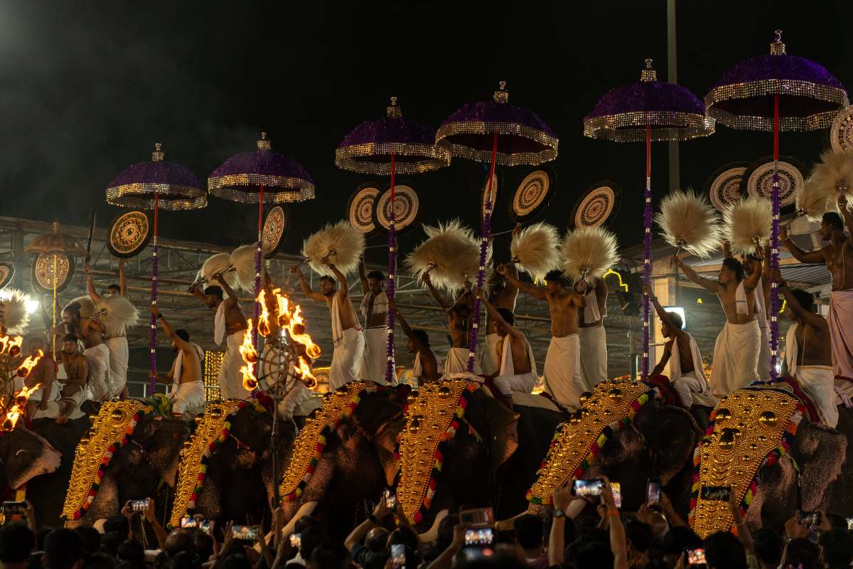 Priests standing on an elephant performing Divine Rituals to a deity.