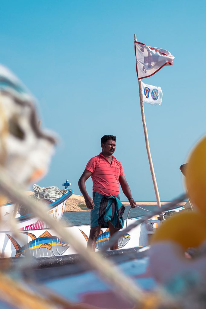 Fisherman standing on a boat.