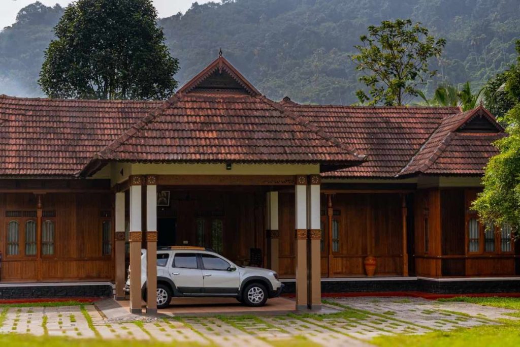 Front view of a traditional Kerala house with wooden architecture.