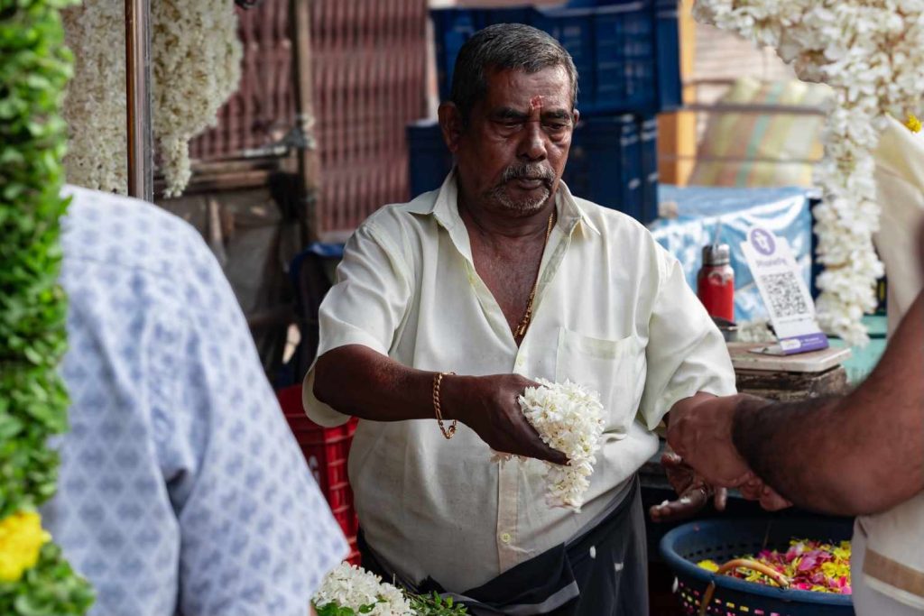 Hands holding fragrant flowers, offering beauty and scent.