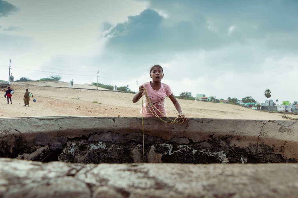 Girl drawing well water