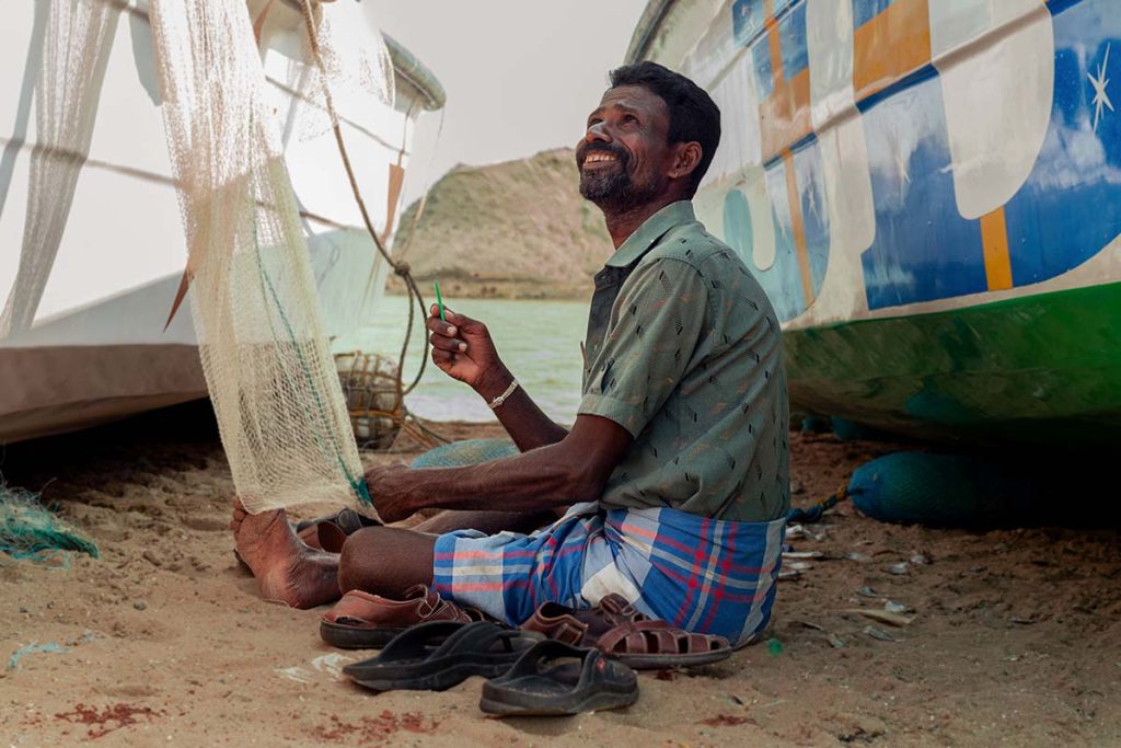 Fisherman mending nets.