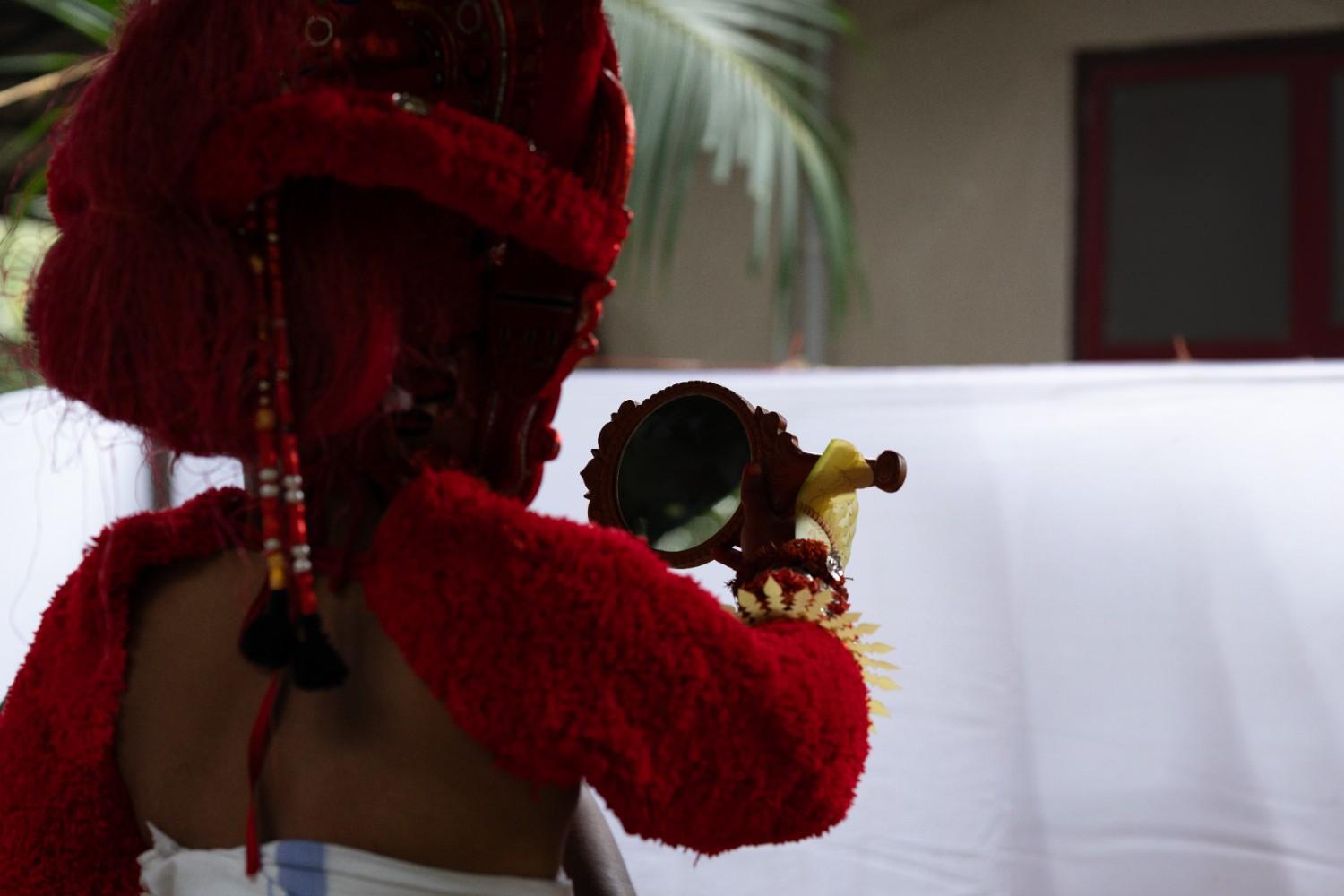 Mirror reflection of theyyam performer
