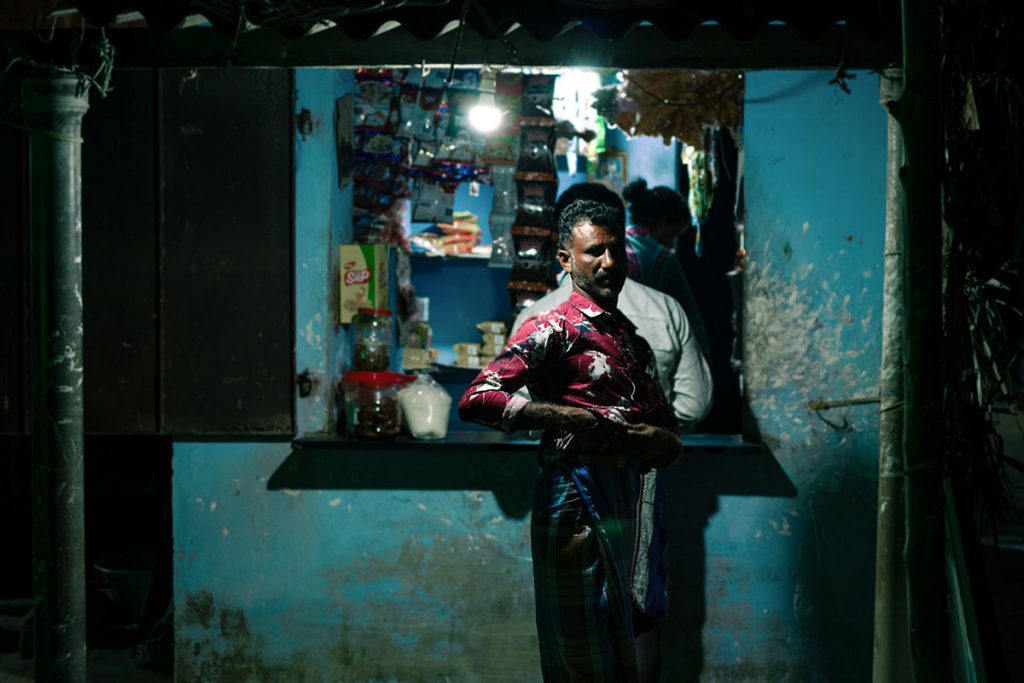 Nightly Mundane   A man outside a local shop. 