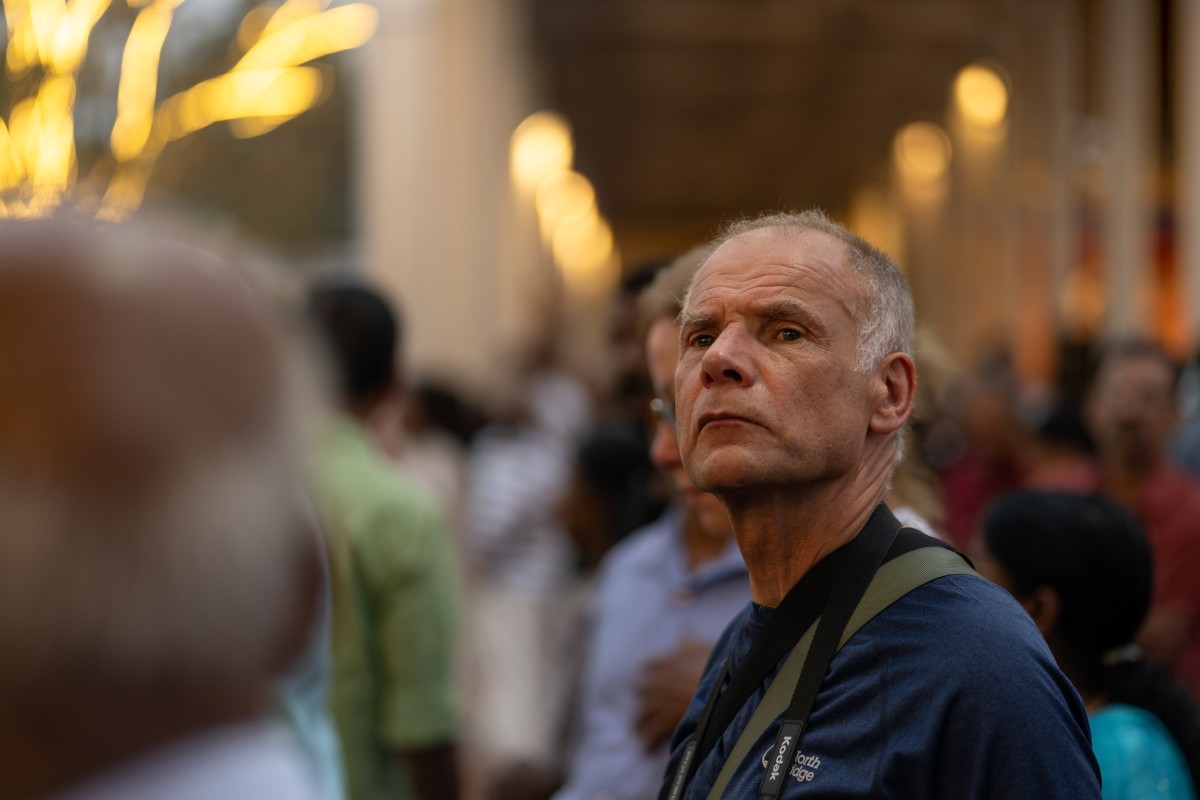 A foreign visitor Observing Culture of a child and the deity procession.