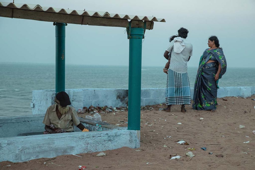 opposite shores Family watching ocean, elder nearby