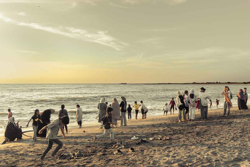 Playful shores as the children run along the beach.