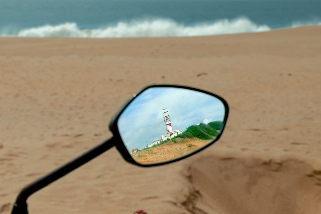 rear reflection of a bike mirror with a reflection.