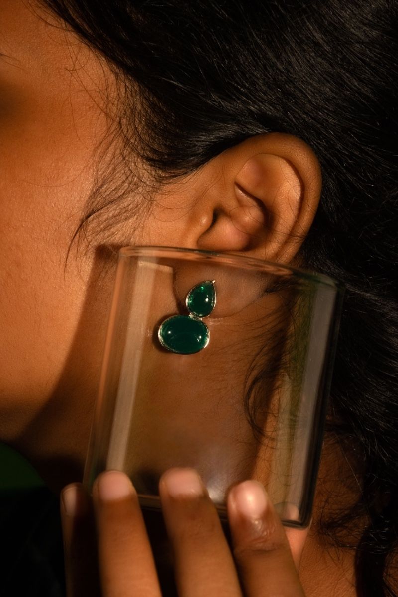 Refined beauty of green color earring framed inside glass.