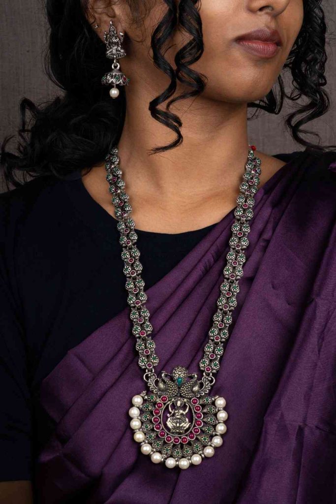 Exquisite oxidized silver necklace adorned with pearls, gemstones, and divine motifs.