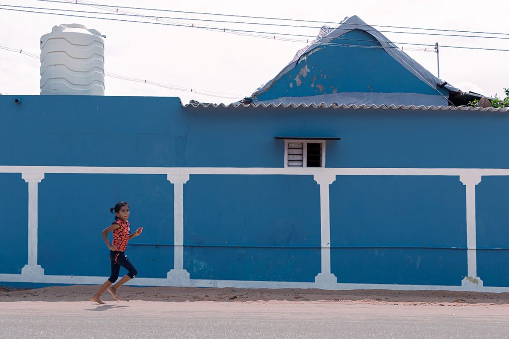 running free . A girl running in the street.