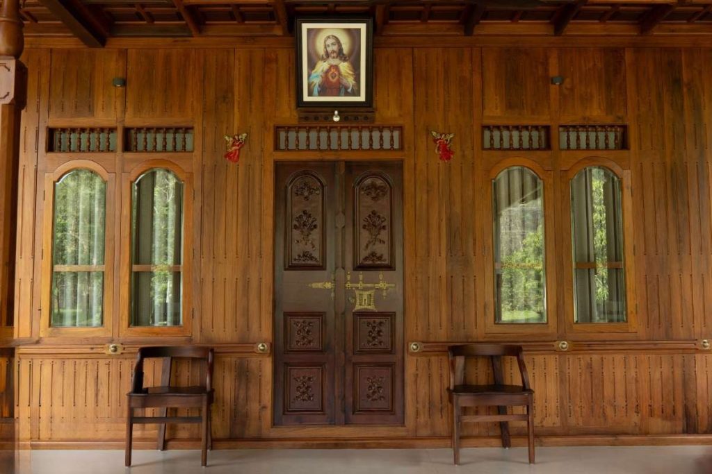 Rustic Kerala house showcasing intricate wooden craftsmanship.