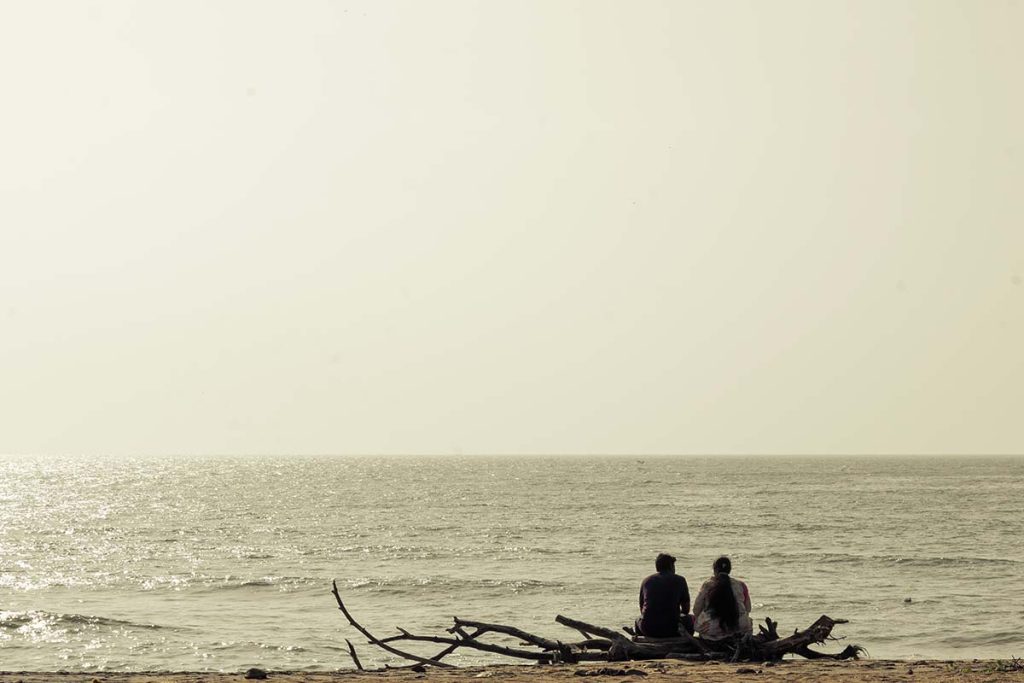 People sharing the moments on the shore watching the sea.