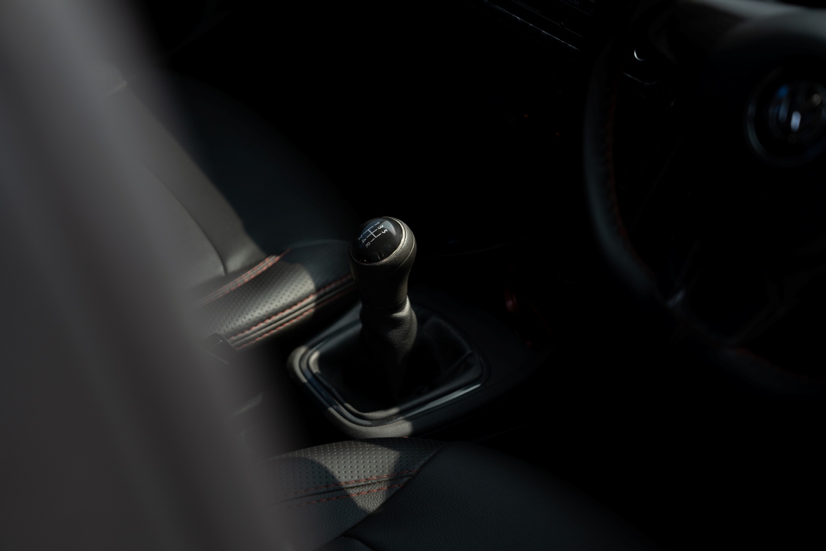 Manual gear lever with red stitching, Shifting Gears.