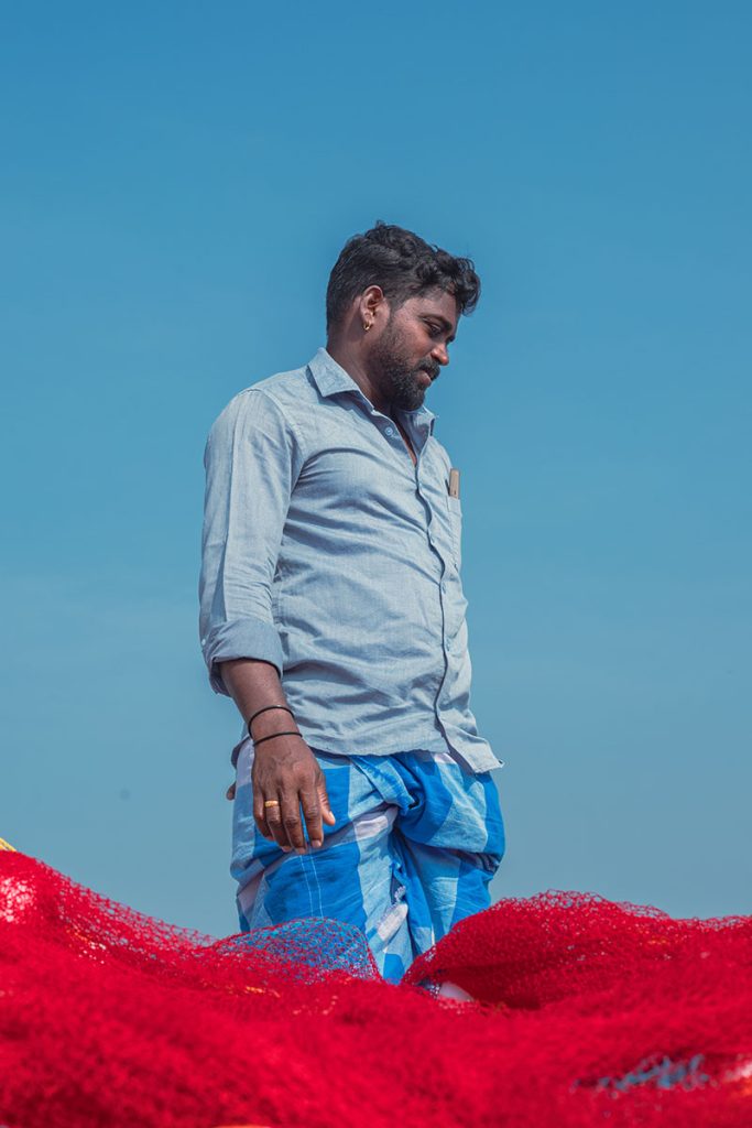 Fisherman standing on a boat.