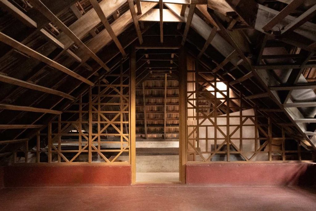 Wooden ceiling with space above for elegance and storage.