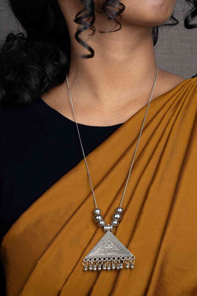 Intricate oxidized silver necklace with vintage-inspired ethnic design.