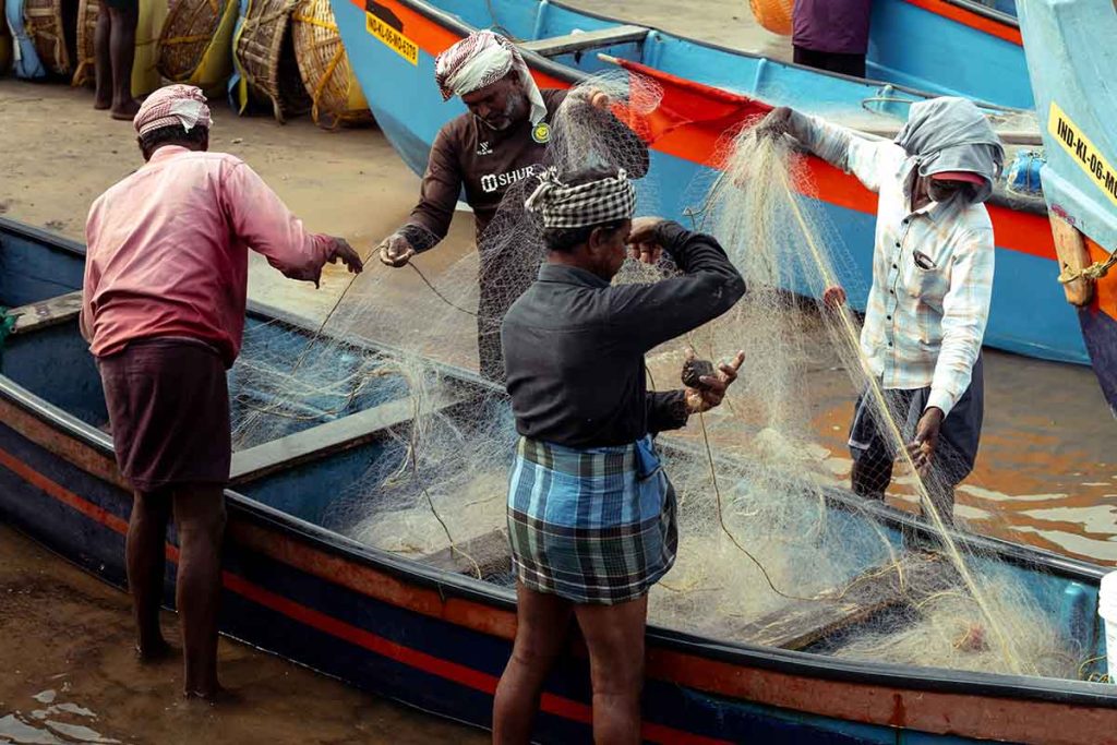 The fishermen untangling the tangled net.