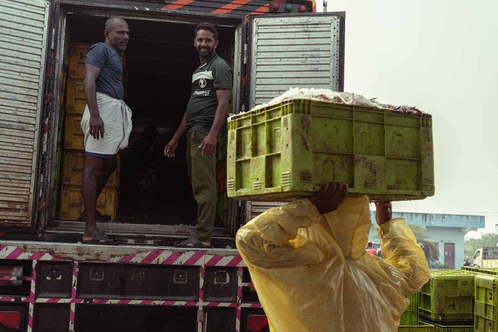 The worker carried the box to the vehicle for transporting.