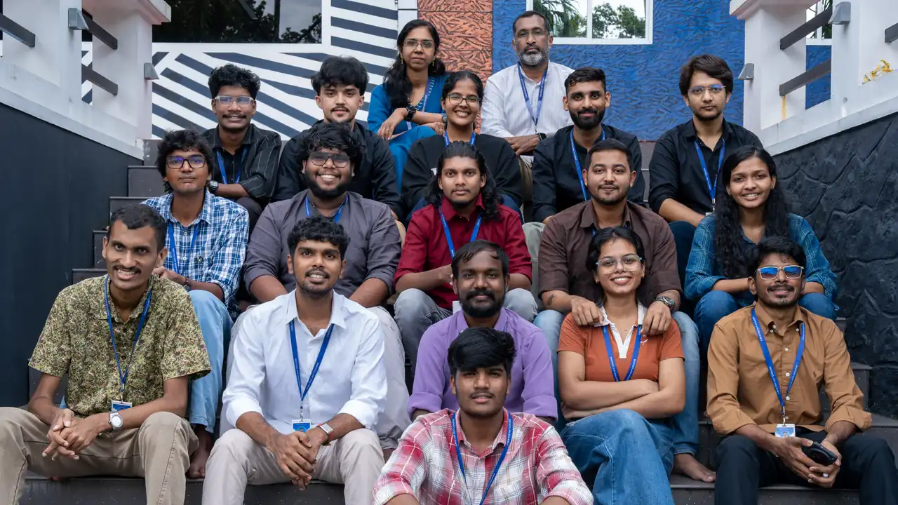 Creative Hut Academy AI filmmaking students and mentors seated together on the campus steps