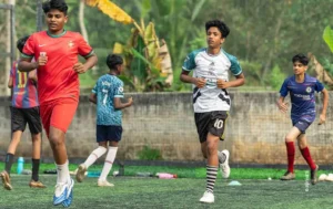 Boys running during a football practice on artificial turf, sports photograph by Ajinlal S, Creative Hut Academy