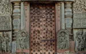 Carved temple door flanked by guardian figures, architecture photograph by Aman, Creative Hut Academy