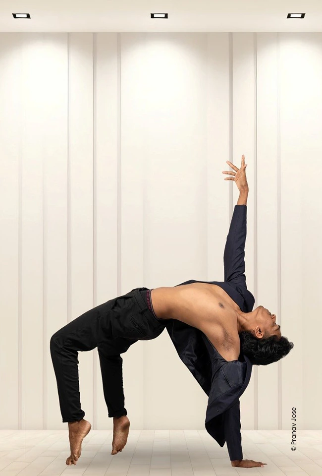Dancer arching backwards in a white studio, advertising photograph by Pranav Jose, Creative Hut Academy