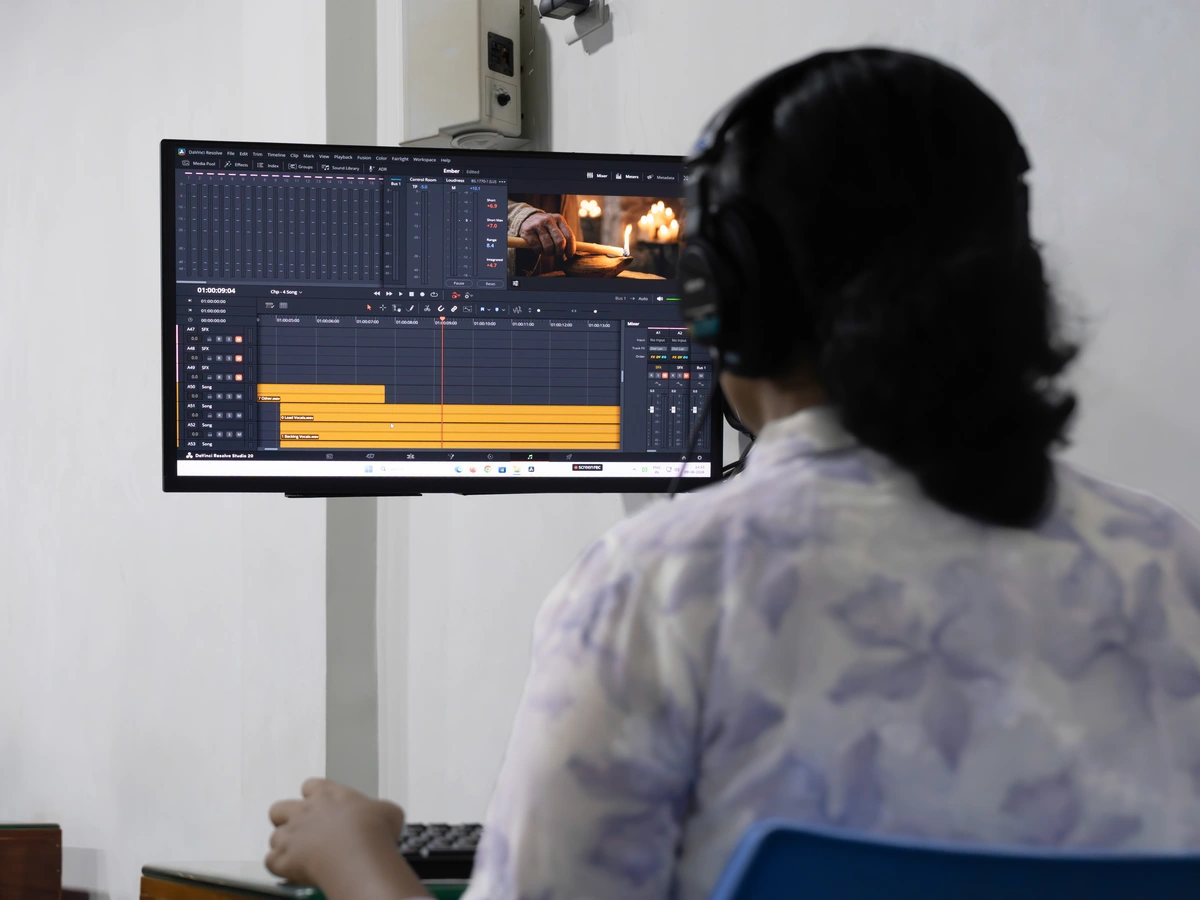 Film student editing on a video timeline in the Creative Hut Academy edit suite