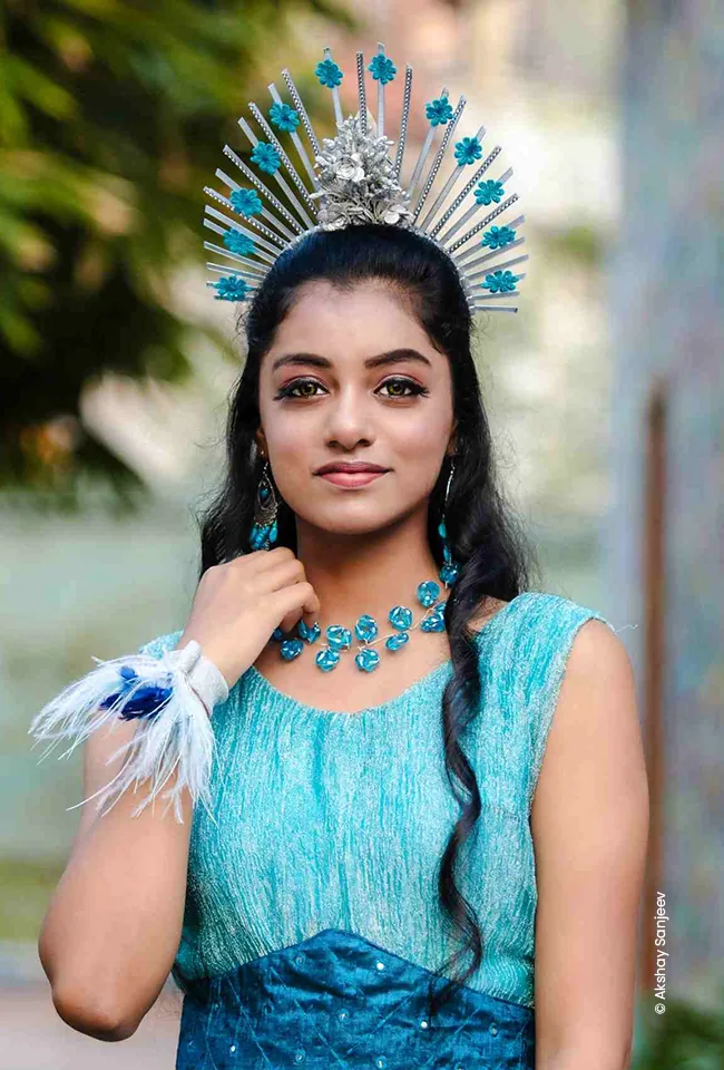 Girl wearing a sunburst crown and blue jewellery, advertising photograph by Akshay Sanjeev, Creative Hut Academy