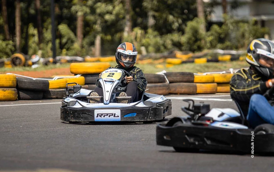 Go-kart driver taking a corner on a tyre-lined track, sports photograph by Abdulk Fayid, Creative Hut Academy