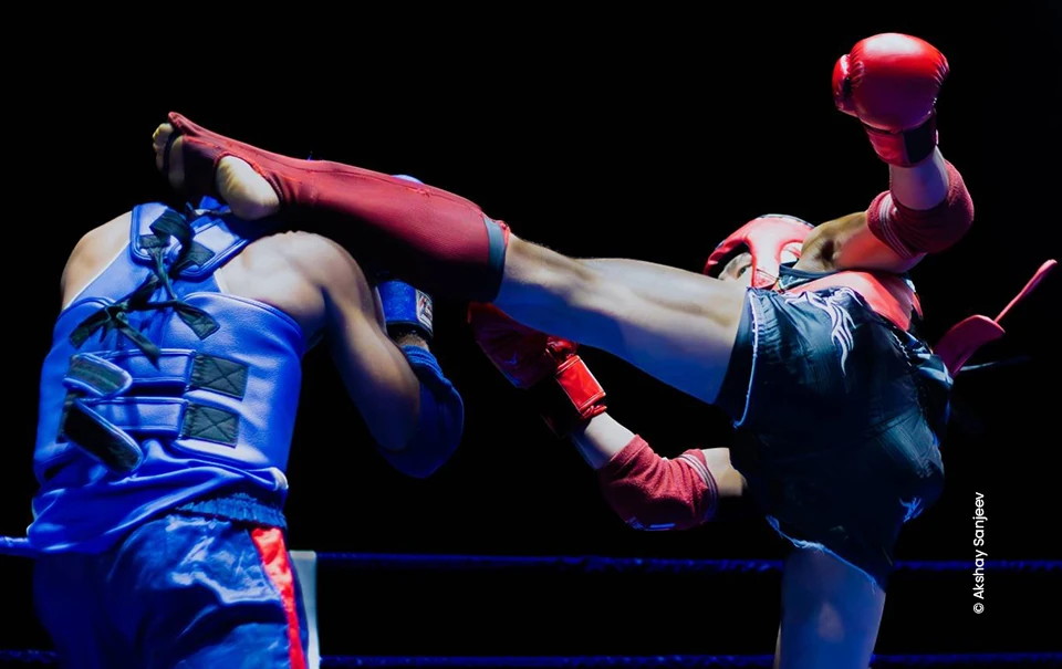 Kickboxer landing a high kick in the ring, sports photograph by Akshay Sanjeev, Creative Hut Academy
