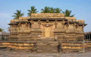 Ornate stone temple facade framed by palm trees, architecture photograph by Narasimha Varma, Creative Hut Academy