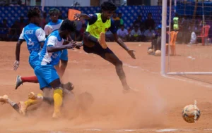 Players tangled in a dusty scramble near the goal, sports photograph by Sarath Mohan, Creative Hut Academy