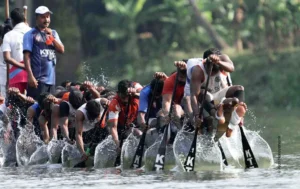Rowers paddling in unison as water sprays during a boat race, sports photograph by Ajay Narayanan K, Creative Hut Academy