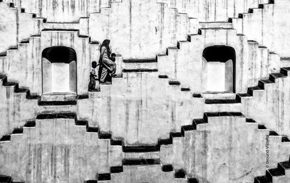 Stepwell with a woman on the stairs in black and white, architecture photograph by Vijay Raj MG, Creative Hut Academy