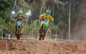 Two motocross riders airborne over a dirt jump, sports photograph by Athira PB, Creative Hut Academy
