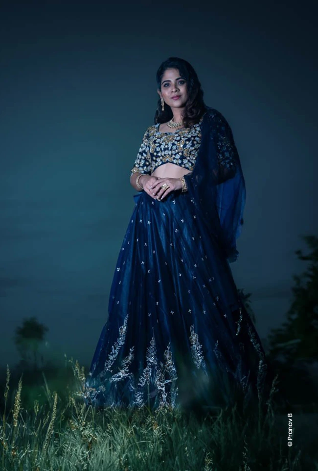 Woman in a blue lehenga on dusky grass, fashion photography course at Creative Hut Academy