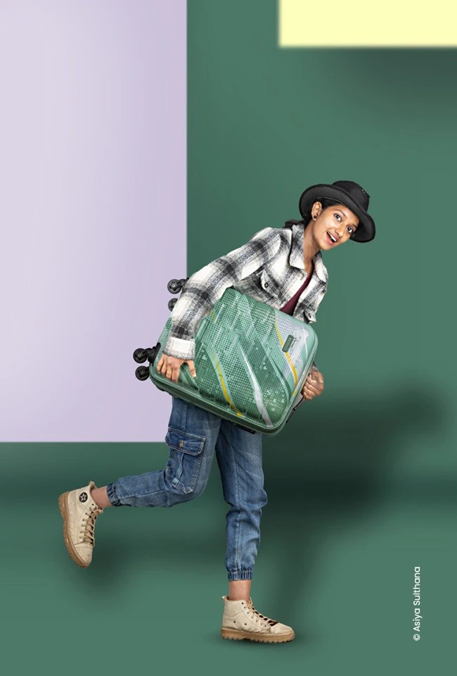 Woman in a hat running with a green suitcase, advertising photograph by Asiya Sulthana, Creative Hut Academy