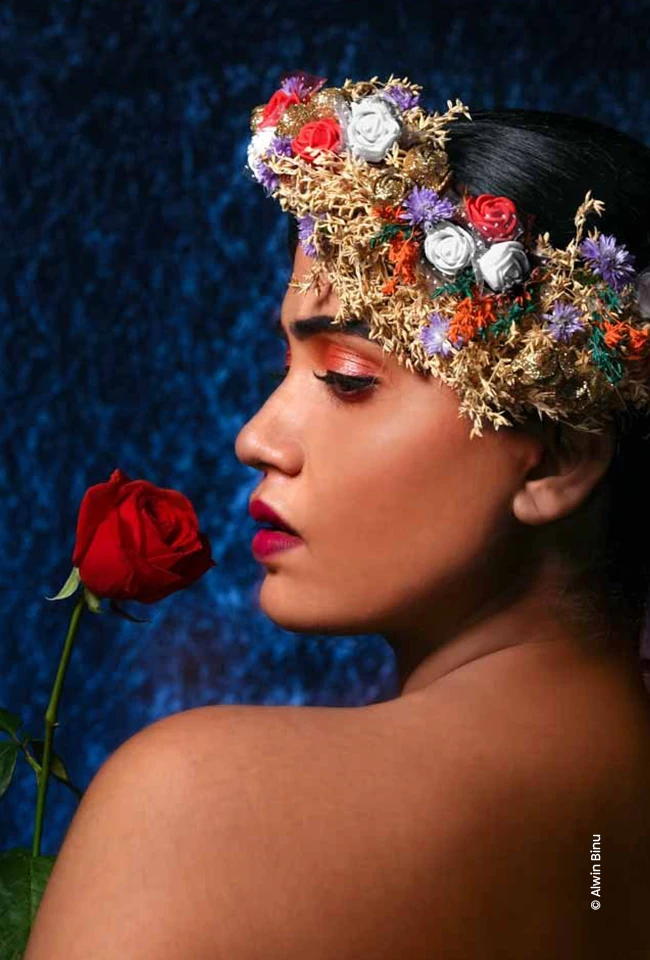 Woman with a floral crown smelling a red rose, advertising photograph by Alwin Binu, Creative Hut Academy